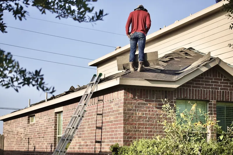 Professional roofer working on a residential roof in Embreeville